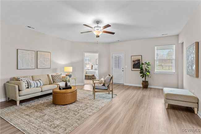 Living area with wood finished floors, a ceiling fan, and baseboards | Image 18