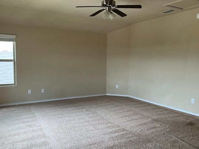 Carpeted empty room featuring ceiling fan and baseboards | Image 17