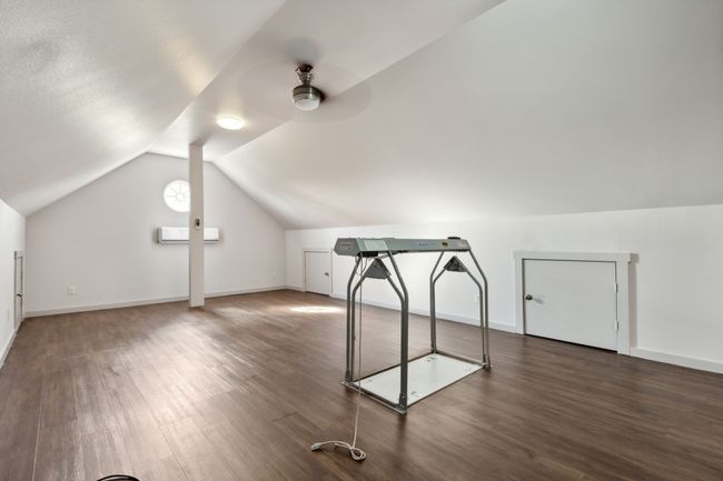 Bonus room with dark hardwood / wood-style flooring, lofted ceiling, and ceiling fan | Image 18