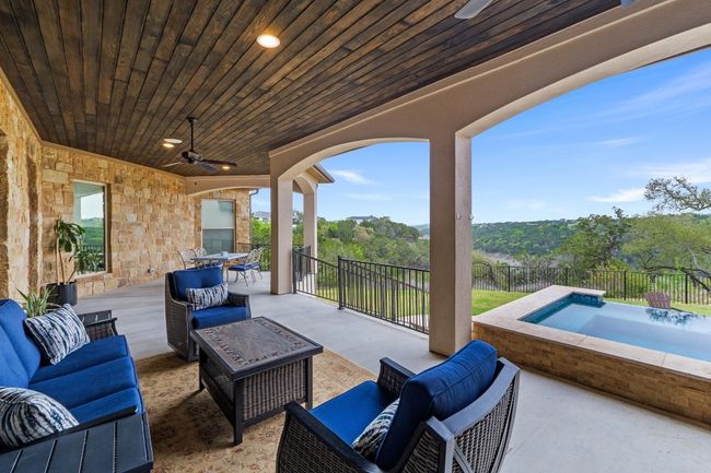 View of patio / terrace with fence, a jacuzzi, an outdoor hangout area, and a ceiling fan | Image 40