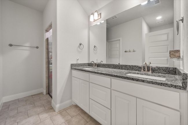 Full bathroom featuring double vanity, tile patterned flooring, and a shower | Image 21