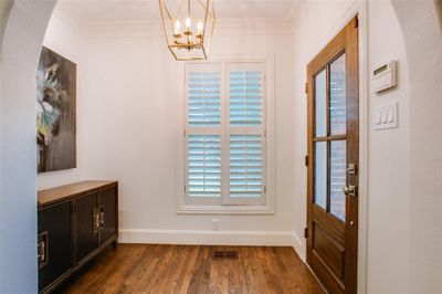 Entrance featuring tall ceilings, arched passage and crown moldings. | Image 3