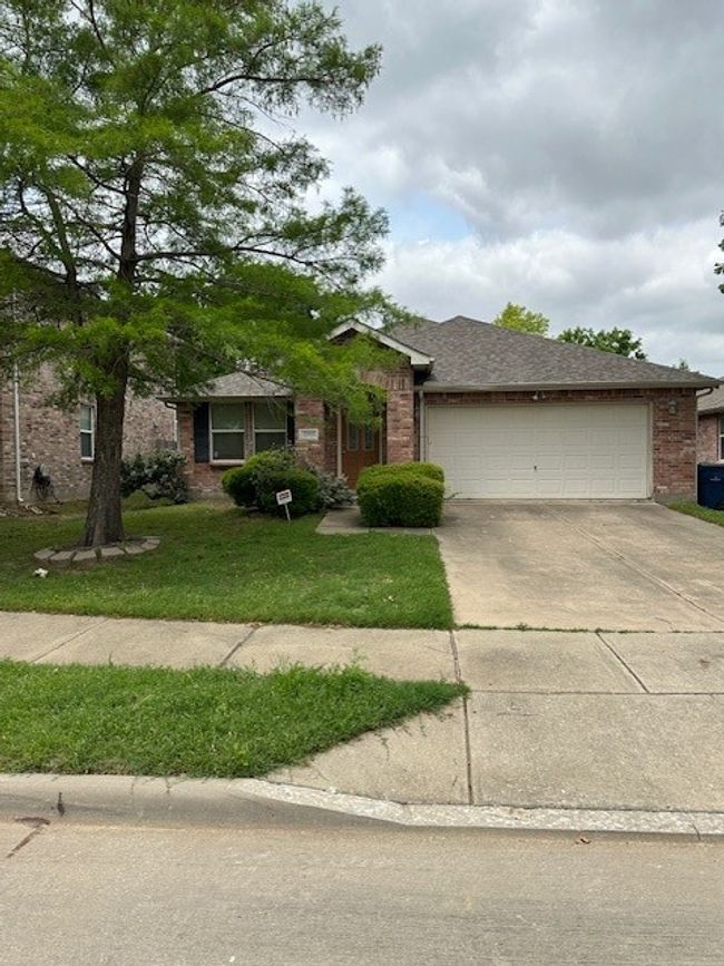 Ranch-style house with driveway, an attached garage, brick siding, and a front yard | Image 20