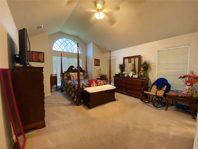 Bedroom with ceiling fan, lofted ceiling, and light carpet | Image 30