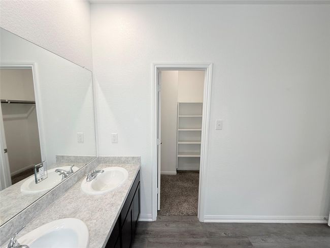 14501 SUGAR PINES DR - Primary bedroom with ensuite bathroom, dual sinks, separate tub and shower, and walk in closet | Image 30