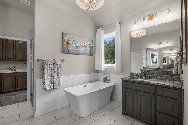 Primary bathroom with natural light, garden tub & separate vanities | Image 19