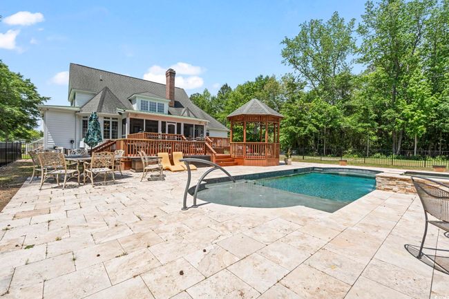 View of pool with a gazebo, fence, and a patio | Image 24