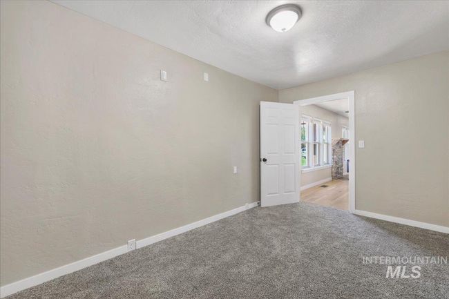 Carpeted spare room featuring a textured wall and a textured ceiling | Image 8