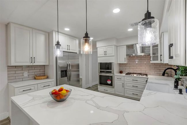 Completely newly remodeled kitchen with new appliances, Quartz countertops, light fixtures and cabinets. | Image 17