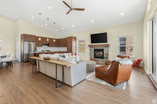 Spacious living room, seamlessly connecting to the kitchen and dining areas, which lead out to a serene balcony. | Image 19