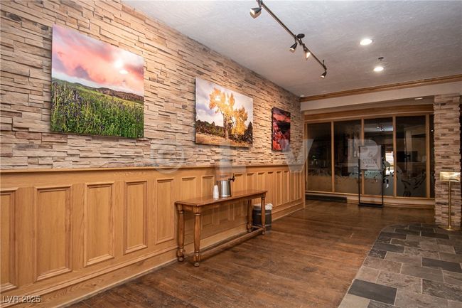 Hallway featuring a wainscoted wall, wood finished floors, and recessed lighting | Image 26