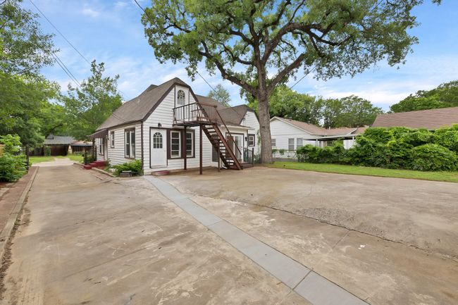 Back side of home featuring driveway, & electric gate | Image 26
