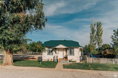 View of front of home featuring central AC and a front yard | Image 1