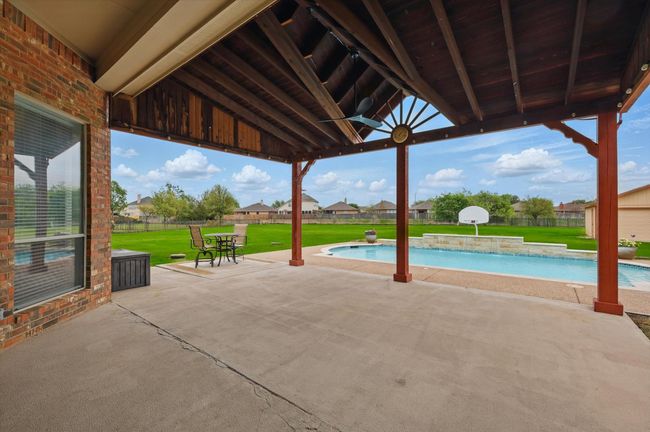 Incredible covered back patio overlooking your 1+ acre lot. | Image 33