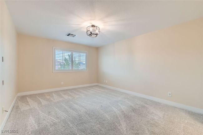 Unfurnished room with light colored carpet and a chandelier | Image 27