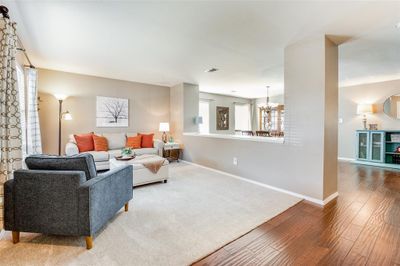 Walk in to beautiful wood floors, new carpet and open concept living! | Image 2