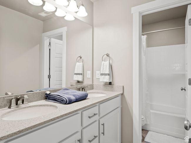 Full bathroom with double vanity and shower / bath combo with shower curtain | Image 22