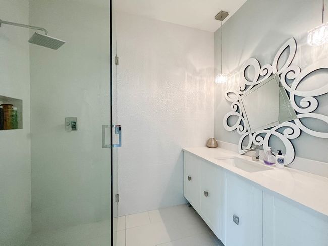 Bathroom featuring a stall shower, vanity, and tile patterned floors | Image 32