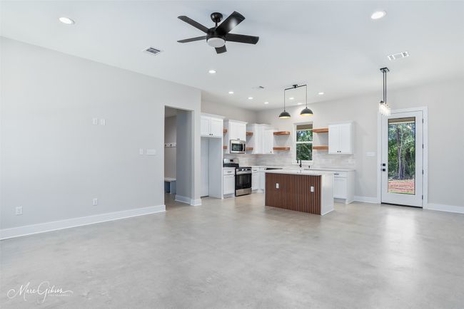 Kitchen featuring open shelves, visible vents, appliances with stainless steel finishes, and open floor plan | Image 7