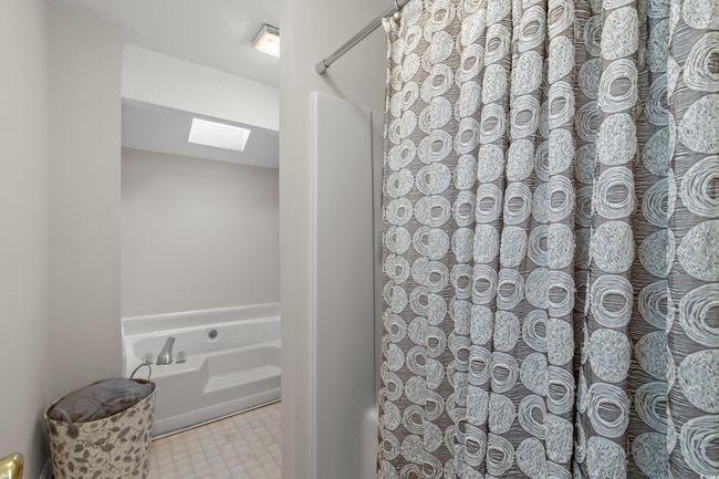 Bathroom featuring a skylight, soaking tub and separate shower. | Image 18
