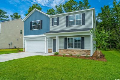 View of front of home featuring a garage and a front lawn | Image 1