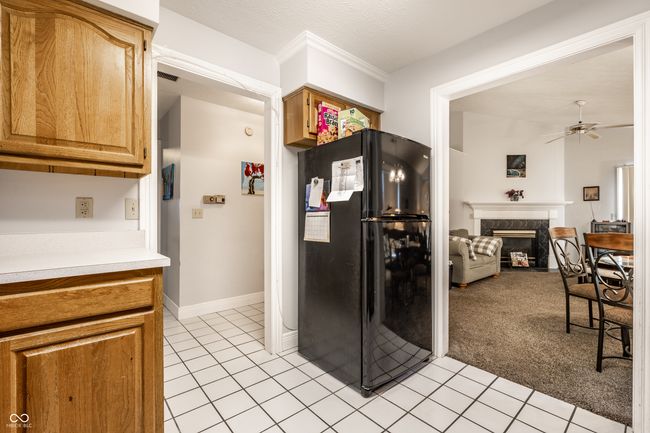 kitchen with view into the dining & living area featuring cozy fireplace | Image 14