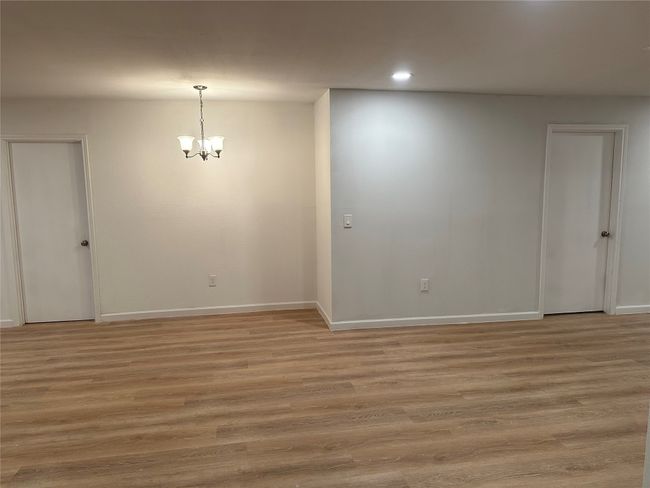 Unfurnished room with recessed lighting, light wood finished floors, baseboards, and a notable chandelier | Image 24