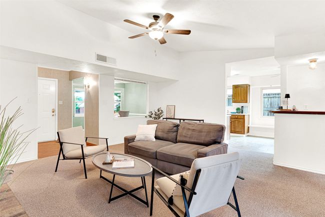 Living area featuring lofted ceiling, a ceiling fan, and light colored carpet | Image 5