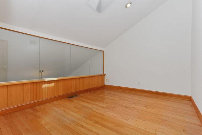 Additional living space featuring hardwood / wood-style flooring, lofted ceiling, and baseboards | Image 22