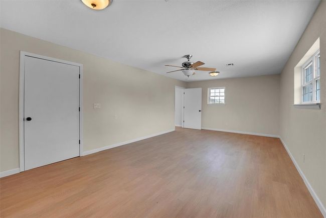 Empty room with light hardwood / wood-style flooring and ceiling fan | Image 27