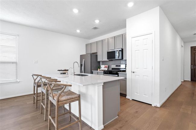 The kitchen island will not disappoint and gives you plenty of space to prepare your meals and spread for family and friends, all while enjoying the open concept living space. | Image 12