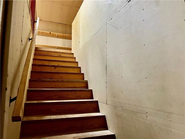 Stairs to rooms above garage and dining area - sheet rocked and with electrical in place | Image 44