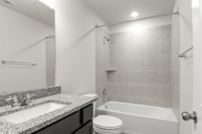 Full bath with visible vents, toilet, shower / bathing tub combination, and vanity | Image 27