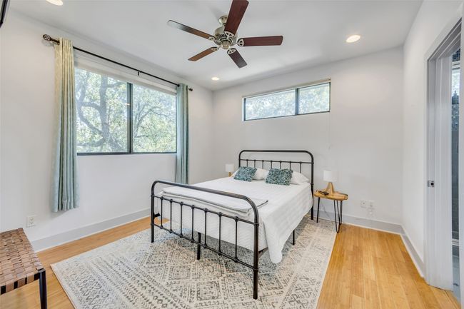 Bedroom with light hardwood / wood-style flooring and ceiling fan | Image 19