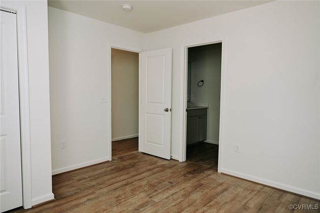 Unfurnished bedroom featuring wood-type flooring and ensuite bath | Image 11