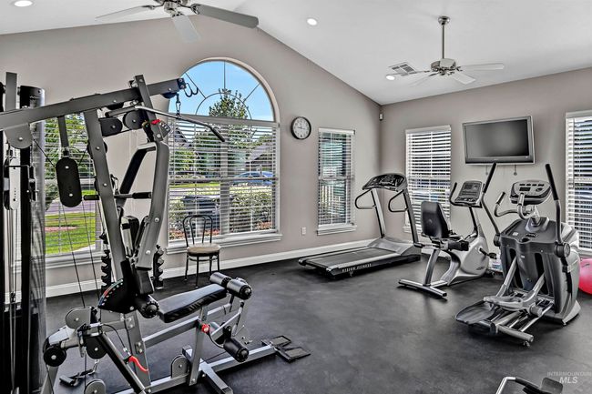 Exercise room with ceiling fan, lofted ceiling, and recessed lighting | Image 24