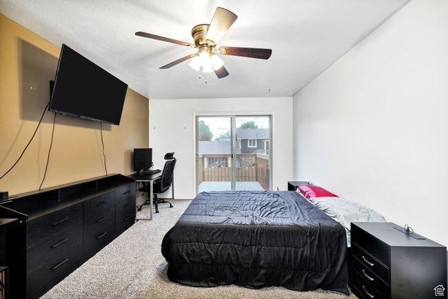 Carpeted bedroom featuring access to exterior, an office area, and ceiling fan | Image 17