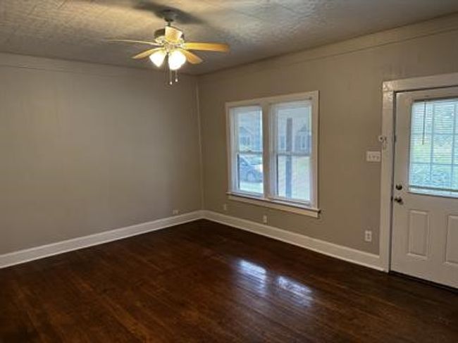 Foyer featuring dark wood finished floors and ceiling fan | Image 11