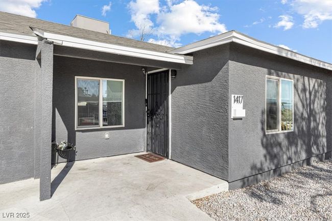 Doorway to property featuring stucco siding and a patio | Image 6