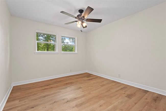 Bedroom 3 with luxury vinyl plank flooring, fresh paint, and new windows | Image 17
