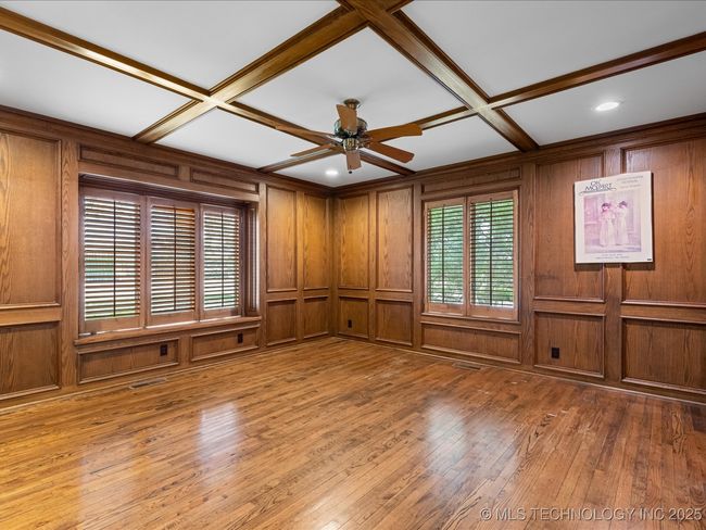 Den with wood flooring, beamed ceiling | Image 22