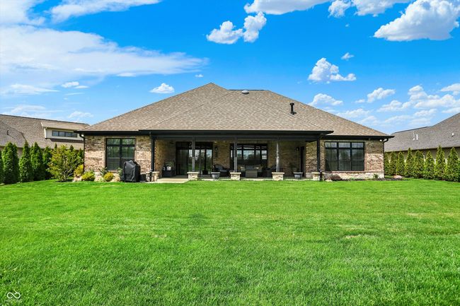 back of property featuring a lawn, brick siding, a patio, and a shingled roof | Image 41