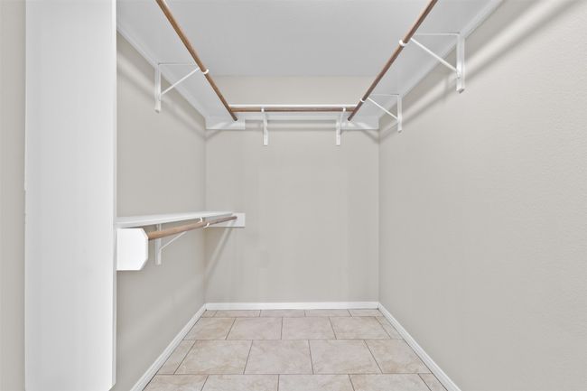Spacious closet featuring light tile patterned floors | Image 18