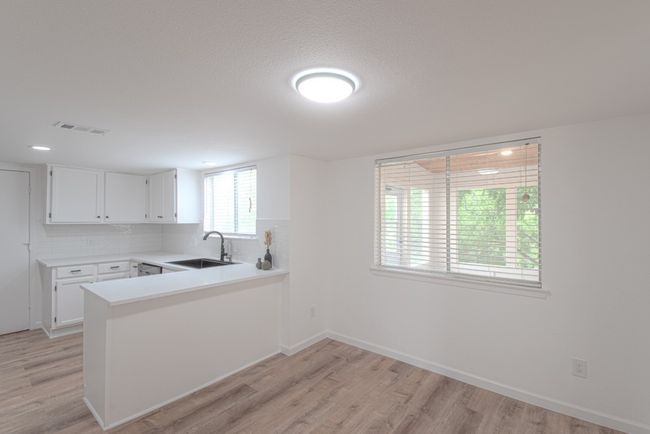 The kitchen overlooks your dining room area and living space. | Image 13