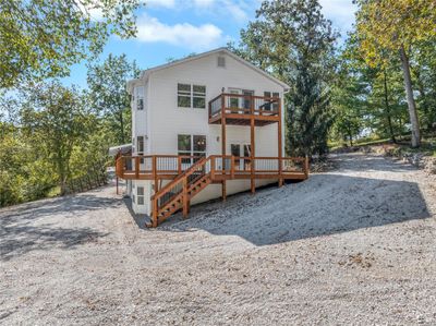 Back house featuring a wrap around deck and balcony from Primary suite | Image 2