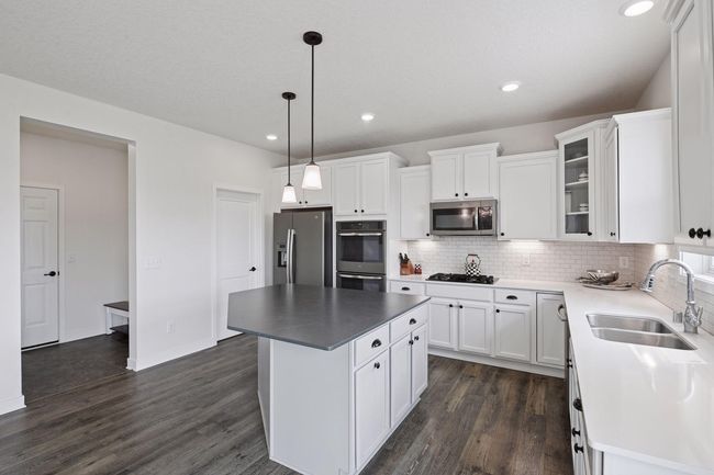 The mudroom is located right off the kitchen | Image 14