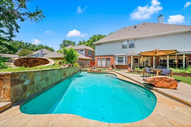 This backyard is one of a kind and not only offers a gorgeous pool but also a "grotto-style" hot tub to enjoy. | Image 6
