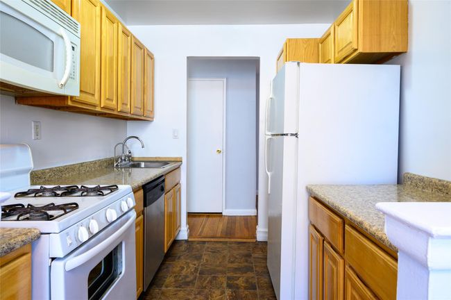 Kitchen featuring sink and white appliances | Image 7
