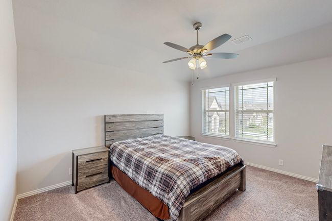 Bedroom with baseboards, visible vents, and light carpet | Image 20