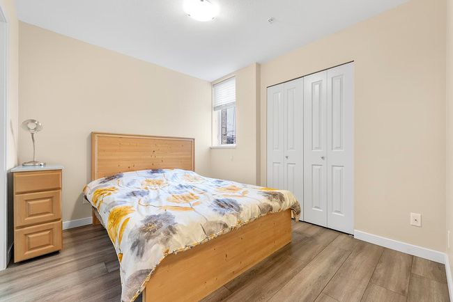 Bedroom with a closet, baseboards, and wood finished floors | Image 11